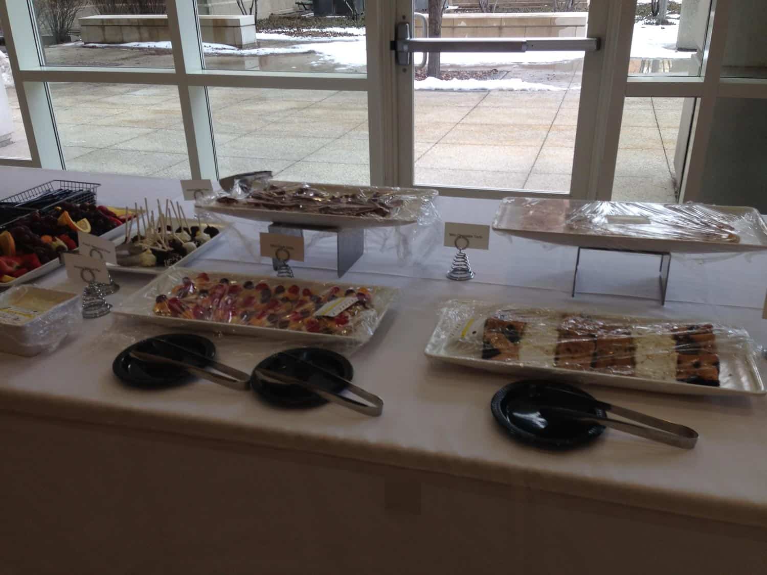 Dessert table with cookies, candies, and pastries at event.
