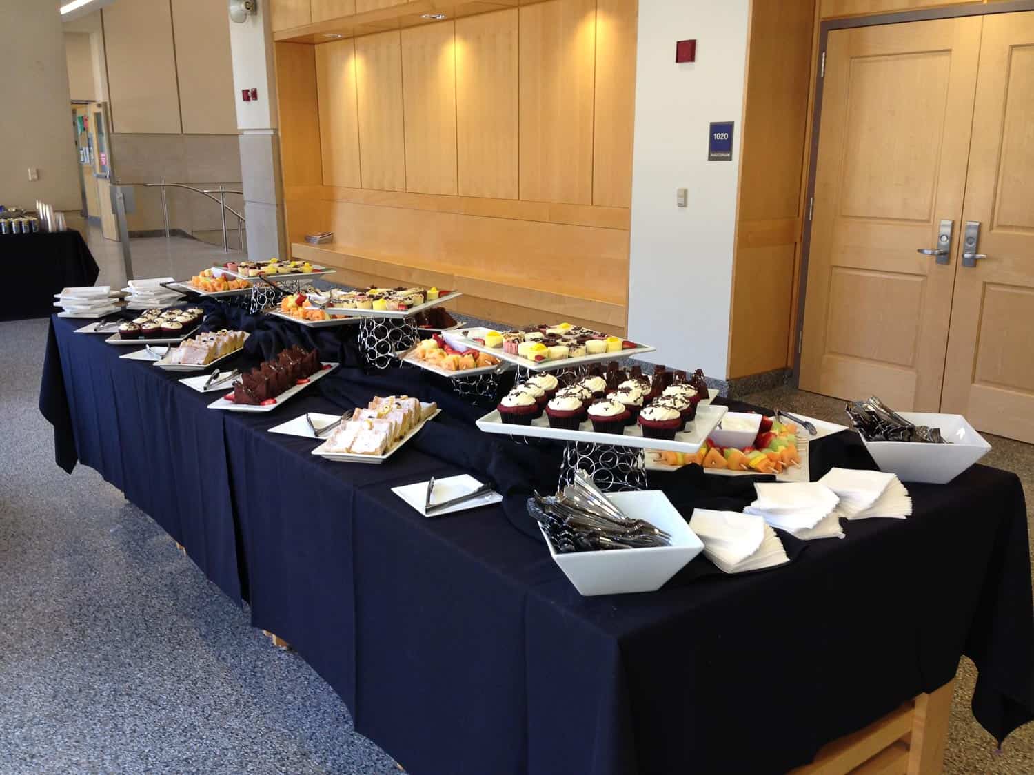 Dessert table with cupcakes, fruit, and snacks at Prime Time Event Planning.