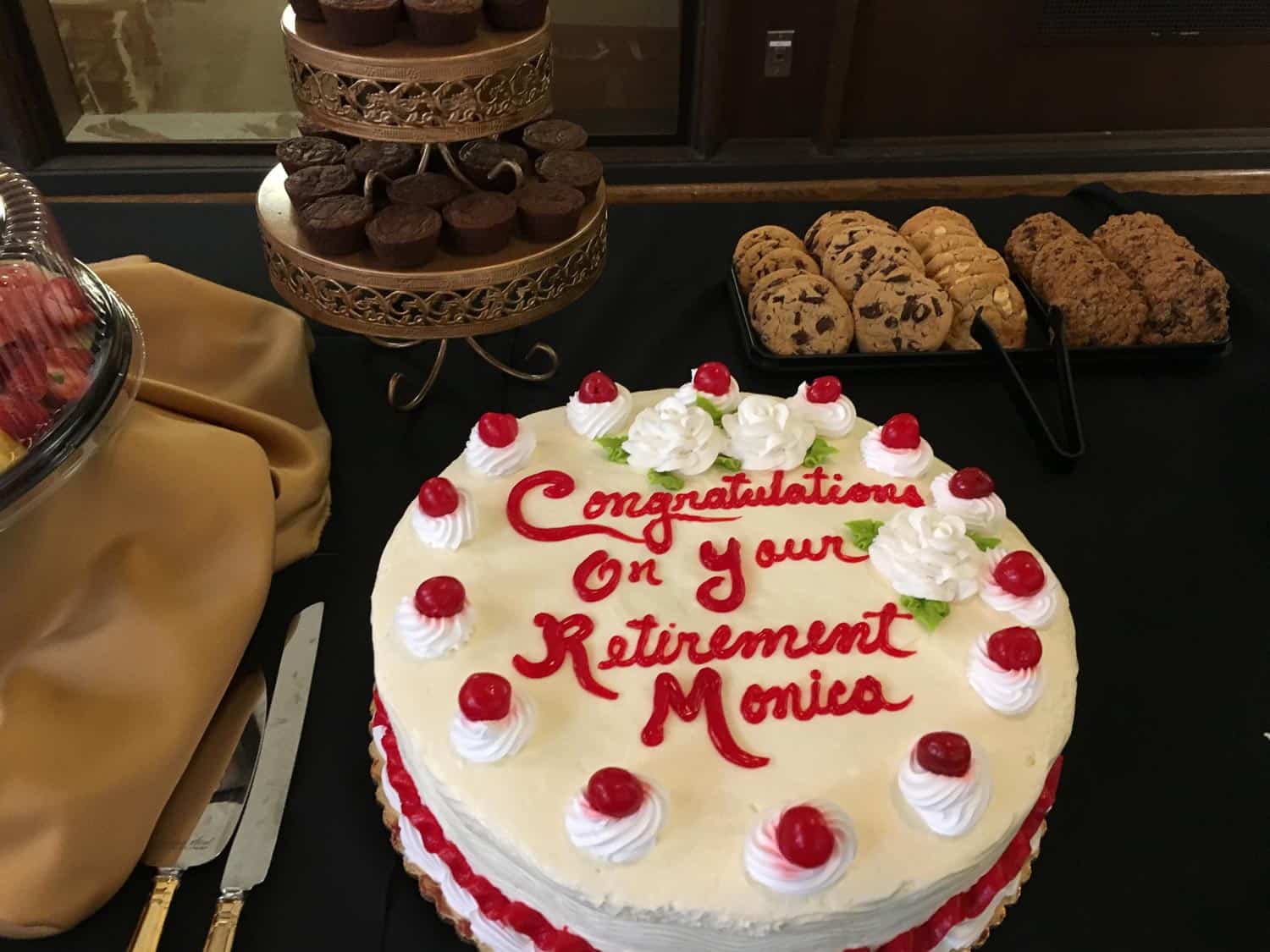 Retirement cake with cherries and whipped cream for Monica's celebration.