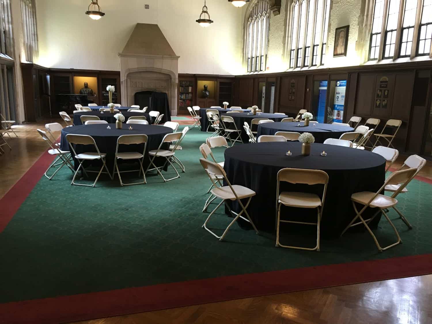 Event space with round tables, chairs, and large windows for hosting events.